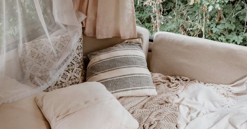 Small Room - Bed with Pillows and Blankets by the Window