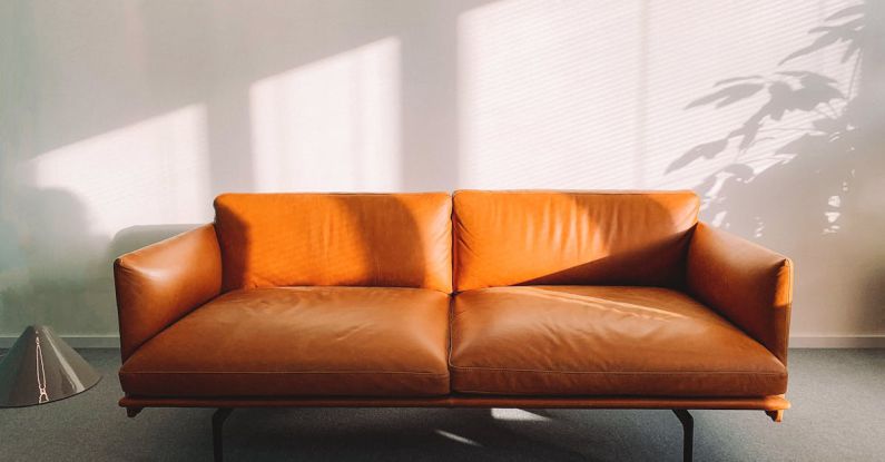 Sofa - 2-seat Orange Leather Sofa Beside Wall