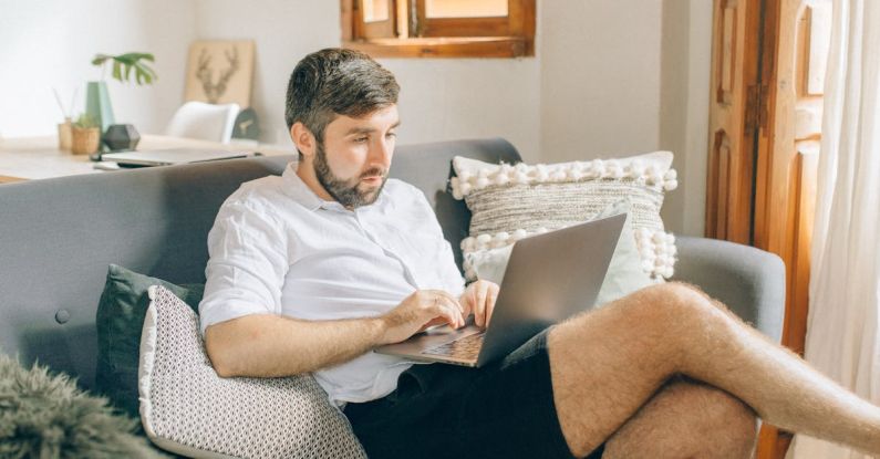 Home Office - A Man Using a Laptop