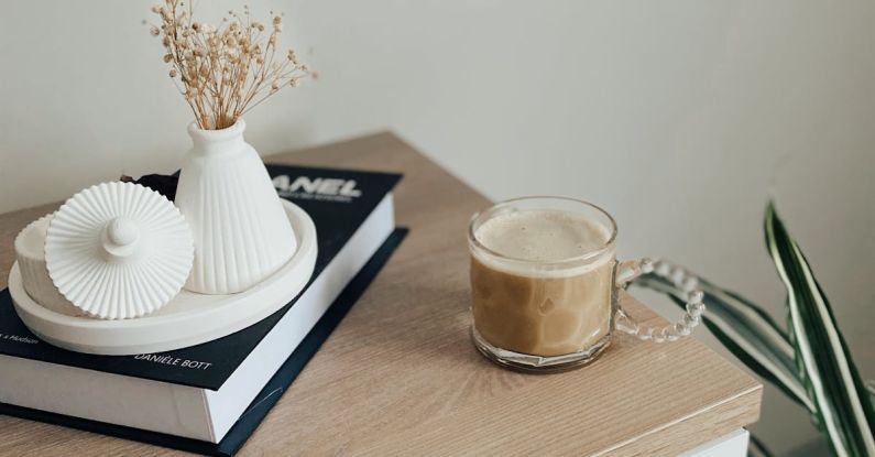 Multifunctional Furniture - A Cup of Coffee Standing next to Decorations on a Dresser