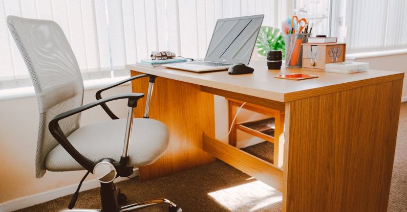 Office Chair - White Rolling Armchair Beside Table