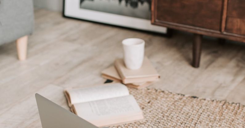 Sofa Styles - Laptop and books on floor carpet