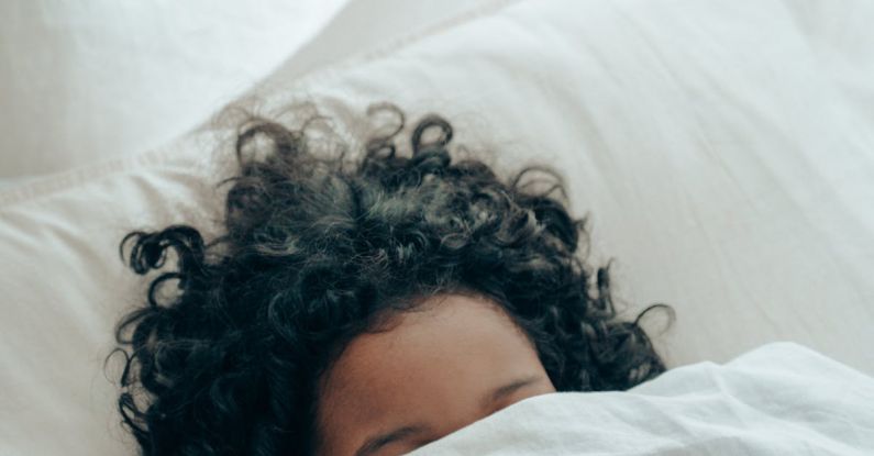 Calm Bedroom - Unrecognizable person sleeping under blanket