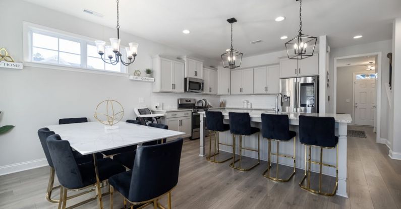 Open Floor Plan - Black Chairs by White Table and Kitchen Island